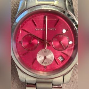Michael Kors women’s pink dial bracelet watch.